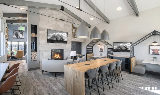 Beautiful business lounge with fireplace Business lounge with TVs, fireplace, and ample seating