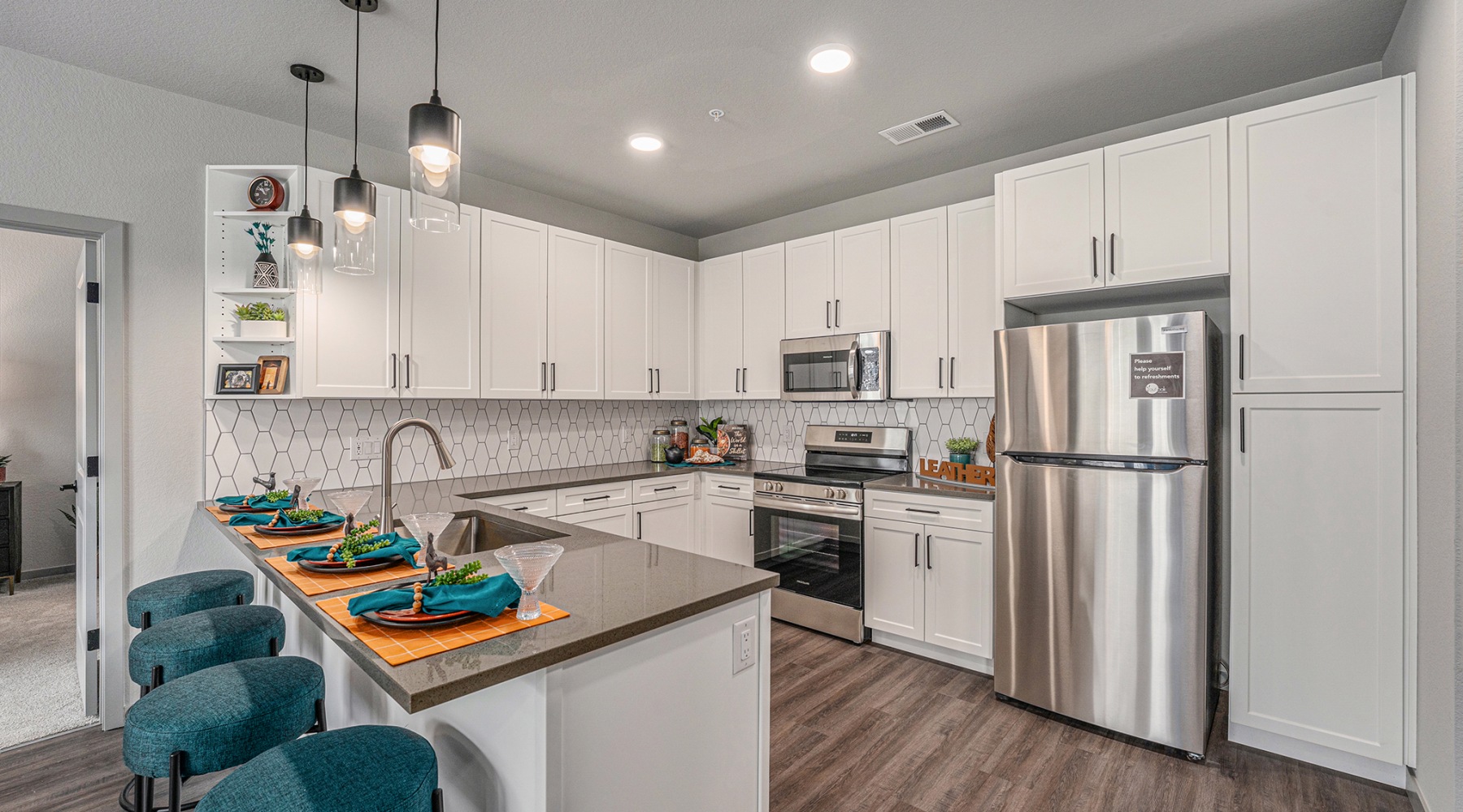 Naturally at Home. Kitchen with storage and stainless steel fridge and gas stove