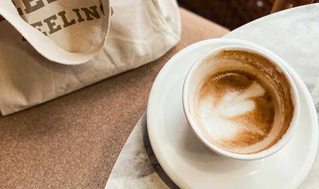 Settle into comfort at Outlook Table Mesa a cup of coffee on a table and a bag on a chair